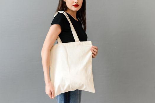 Woman with eco bag on grey background. Mock up for design tote bag
