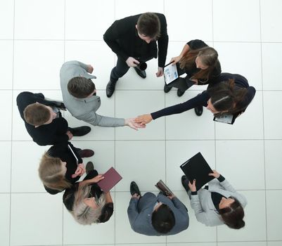 top view. financial partners confirming the transaction with a handshake.