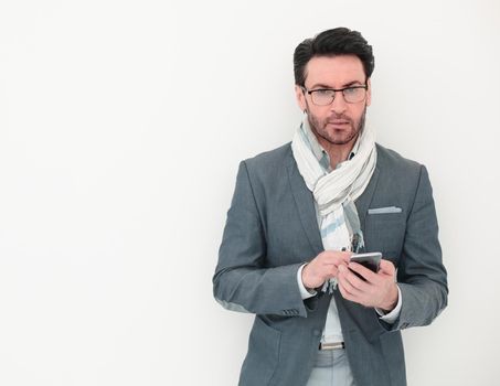 businessman with scarf on neck typing SMS on smartphone.