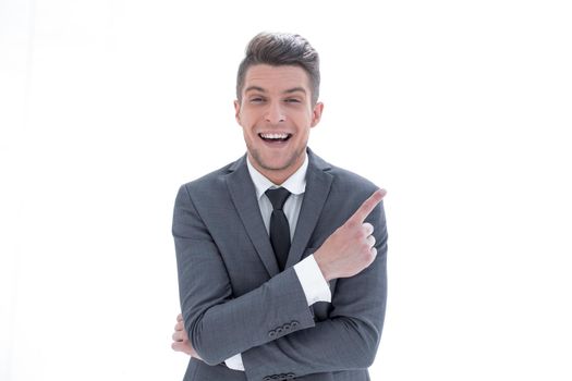 Young handsome businessman with beaming smile pointing with finger