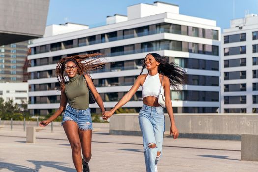 two african girls have a blast around the city