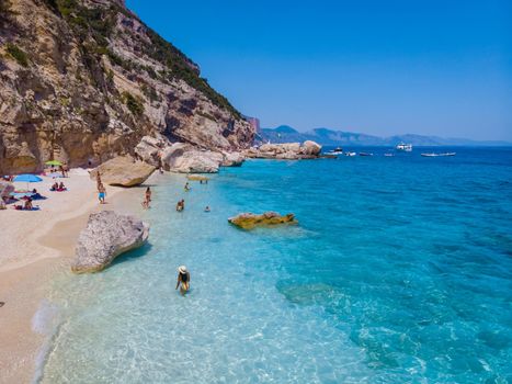 Golfo di Orosei Sardina, Asian women on the beach Sardinia Italy, young girl on vacation Sardinia Italy, woman playing in the ocean with crystal clear blue water,