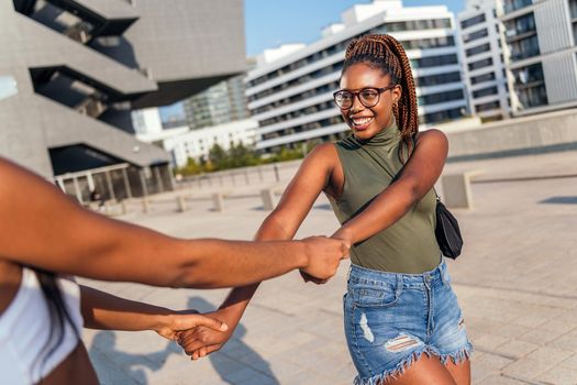 two young black friends have fun strolling through the city, concept of friendship and urban lifestyle