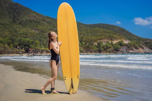 Beuatiful surfer girl making preparation for a surf session