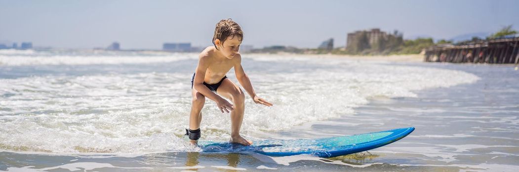 Healthy young boy learning to surf in the sea or ocean BANNER, LONG FORMAT