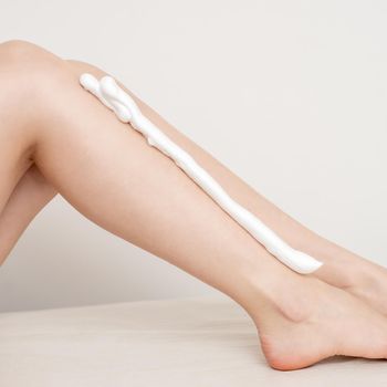 Bare legs with shaving foam