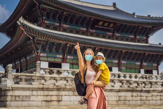 Mom and son tourists in medical mask in Seoul, South Korea. Travel to Korea concept. Traveling with children concept Tourists fear the 2019-ncov virus. Medical masked tourists