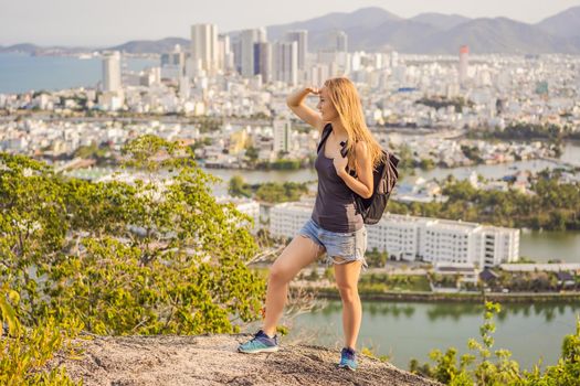 Woman tourist on the background of Nha Trang city. Travel to Vietnam Concept