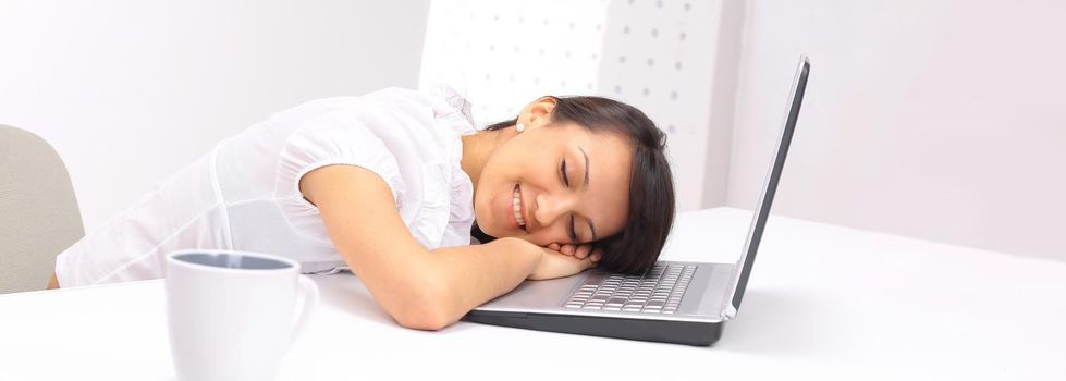 closeup.young business woman sleeping on the laptop keyboard