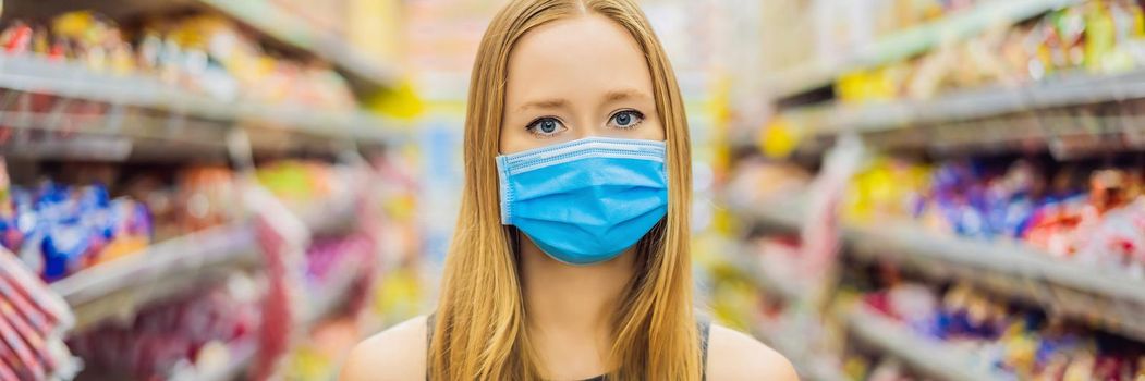 Alarmed female wears medical mask against coronavirus while grocery shopping in supermarket or store- health, safety and pandemic concept - young woman wearing protective mask and stockpiling food. BANNER, LONG FORMAT