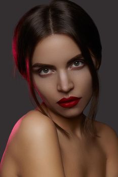 Beautiful model with fashion make-up. Close-up portrait sexy woman with glamour lip gloss makeup and bright eye shadows.