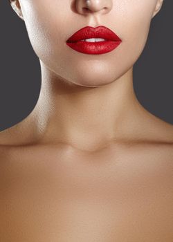Cosmetics, makeup. Bright lipstick on lips. Closeup of beautiful female mouth with red and red lip makeup. Part of face
