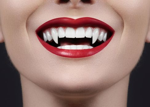 Sexy Female Vampire Lips. Monster Smile. Halloween Style with Red Blood Makeup Lip. Masquerade Look with Terrible Fags