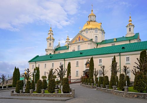 Religious buildings. Pochayiv, Ukraine, 2021, may - orthodox church with golden domes, Trinity cathedral and bell tower in Pochaev Lavra