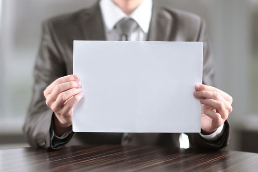 close up.businessman showing blank sheet of paper