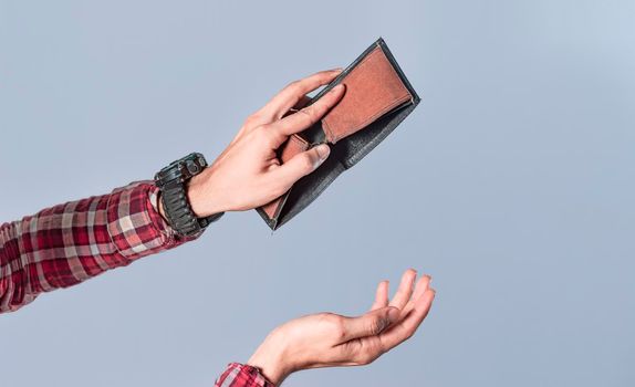 Concept of an empty wallet, hand opening empty wallet on isolated background, concept of economic crisis