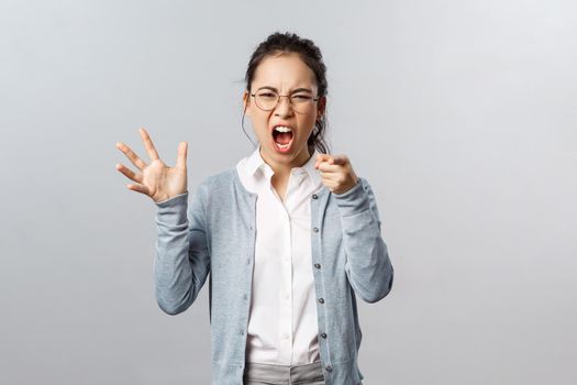 Emotions, family therapy and lifestyle concept. Its your fault. Angry asian woman blame her husband during argument, pointing finger with scold, accusing in cheating her, scream and arguing