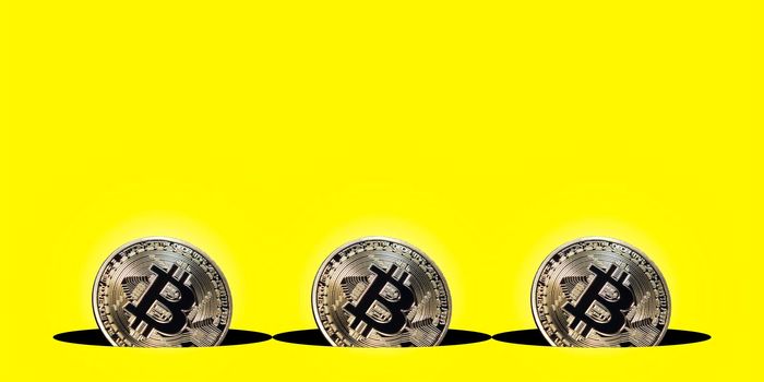 Virtual cryptocurrency concept, bitcoin gold coin on yellow background with copy space, bitcoin gold coin
