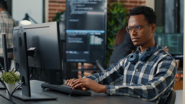 African american software developer working on office PC