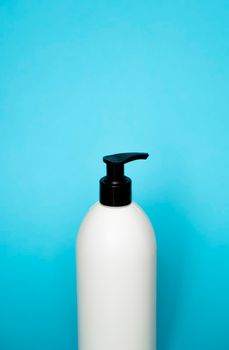 Plastic shampoo bottle on a blue background. Mock up template for design.