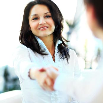 Business woman gives a handshake