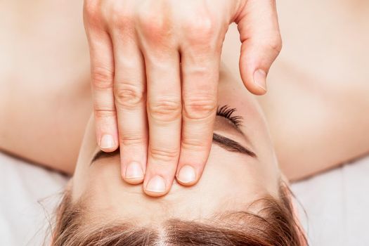 Forehead massage of woman.