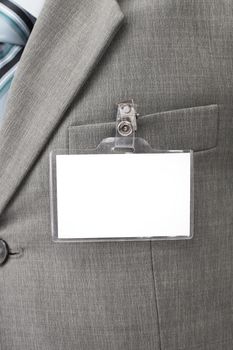 White blank name tag is attached to chest of a businessman .