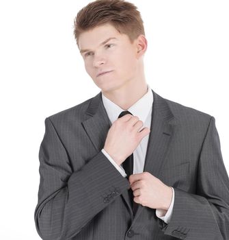 young businessman adjusting his tie.isolated on a white