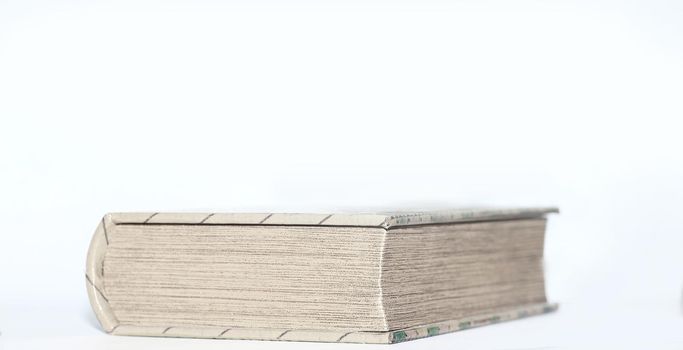 close up.thick closed book on white background