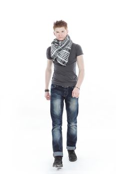 young man in a t-shirt and scarf ,confidently goes forward.