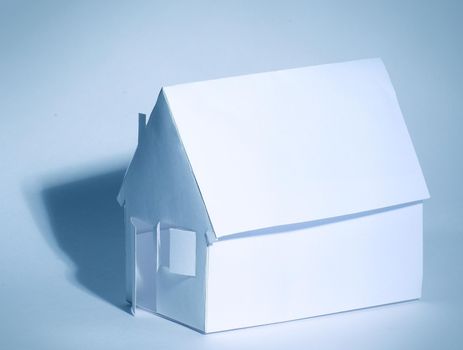 Paper house on a white background in cool colors