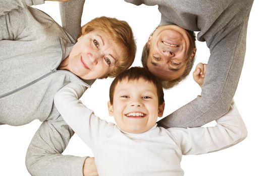 Grandmother with grandfather and grandson hugging in a circle. concept-happy family