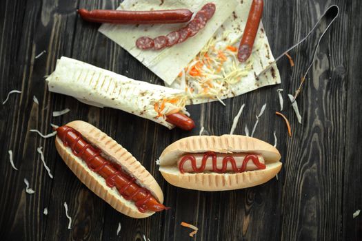 fast food.sausage in pita bread and hot dog on wooden background