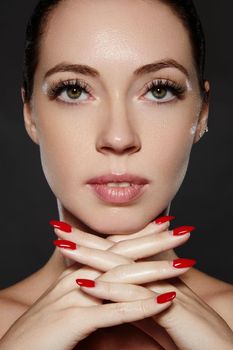 Beautiful woman show her erfect face with fashion make-up. Extreme eyelashes, plump lips, clean skin. Fresh spa look