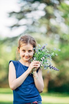 little girl with a bouquet of wildflowers