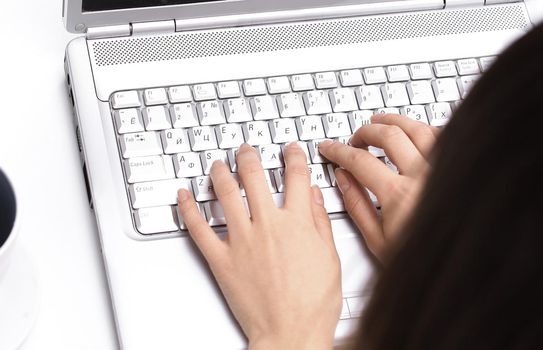 closeup.young woman typing text on laptop keyboard