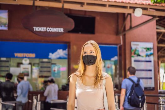 young woman wearing a hygiene protective mask over her face while walking at the crowded place. Healthcare and sickness prevention from coronavirus, Covid19 influenza in crowded place