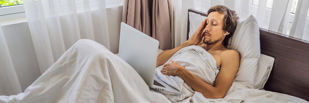 Male patient is sick while lying in his bed and calls an online doctor through a gadget BANNER, LONG FORMAT