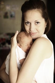 young mother with a newborn infant in the room