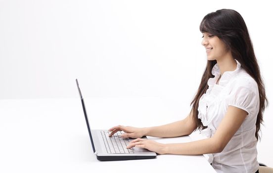 young woman typing text on laptop keyboard