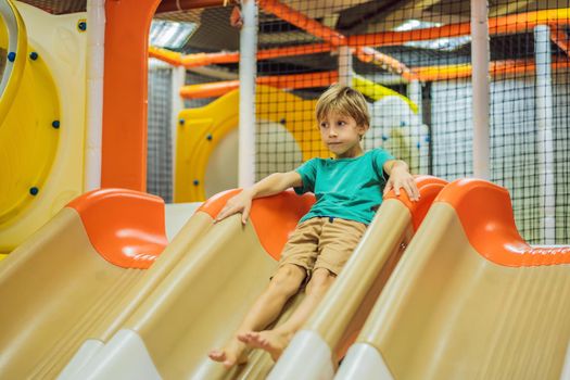 The boy has fun in an indoor playground