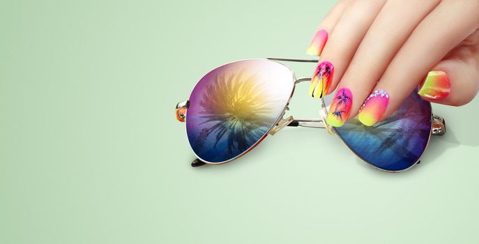 Summer fashion and beauty hand care concept with sunglasses