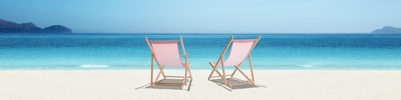Relax on tropical beach in the sun on deck chairs.