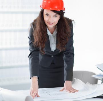 female architect working with blueprints in the office