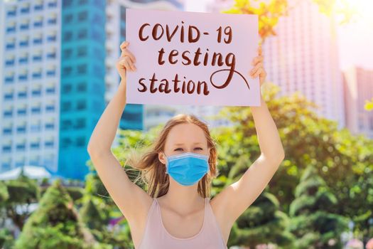 woman in medical mask prevents coronavirus disease holds a poster coronavirus testing sign Hand written text - lettering isolated on white. Coronovirus COVID 19 concept