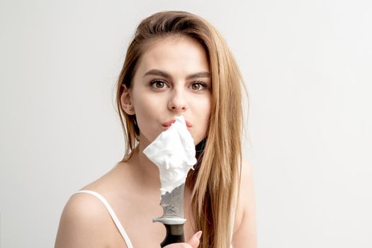 Woman holding knife with shaving foam