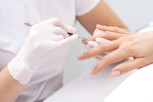 Woman receiving nail care procedure