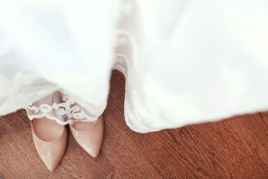 Beautiful wedding shoes under the dress