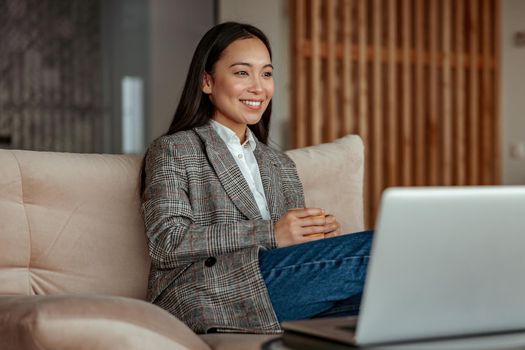 Smiling beautiful business asian woman working in office use computer