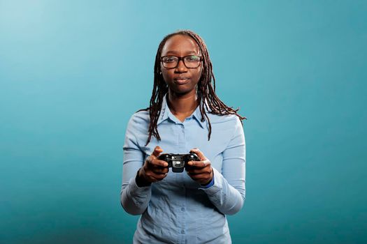African american woman with modern console controller playing videogames